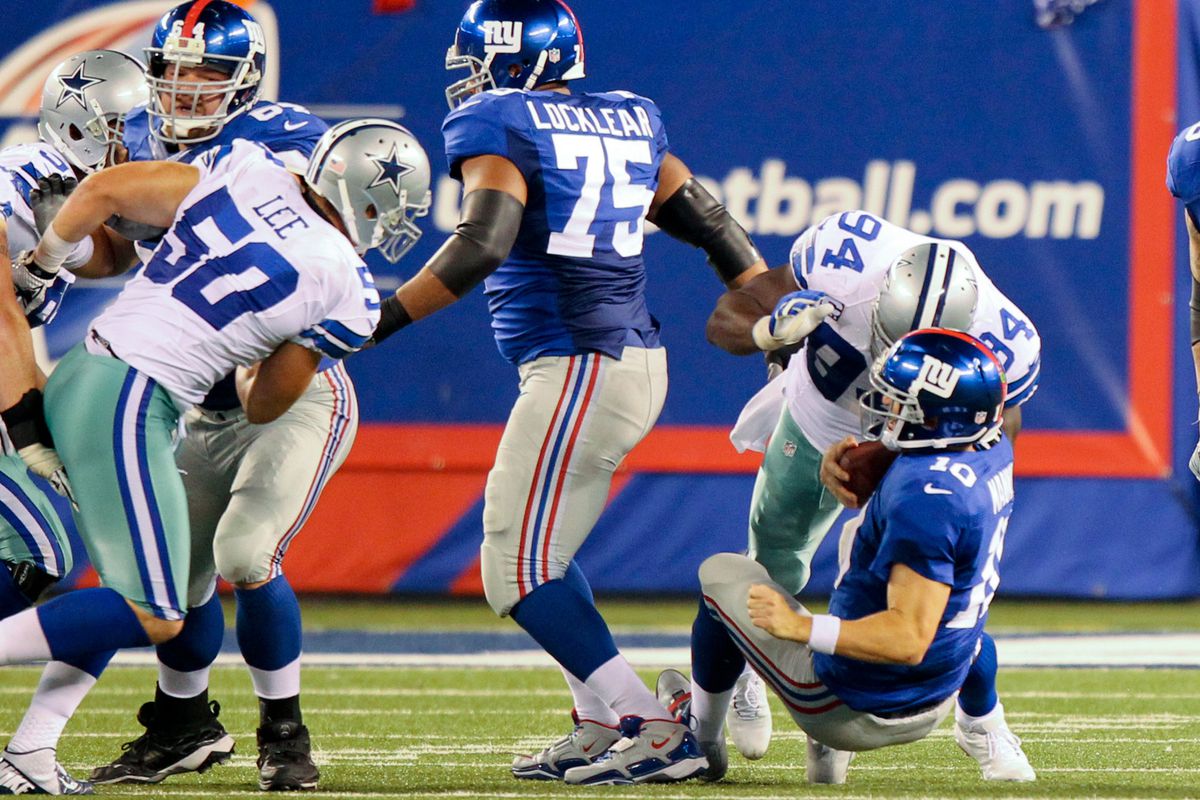 Sep 5, 2012; East Rutherford, NJ, USA;  New York Giants quarterback Eli Manning (10) gets sacked by Dallas Cowboys linebacker DeMarcus Ware (94) during the second quarter at MetLife Stadium. Mandatory Credit: Anthony Gruppuso-US PRESSWIRE