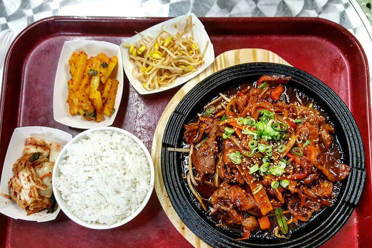 Spicy pork bulgogi and assorted banchan at Reliable Market