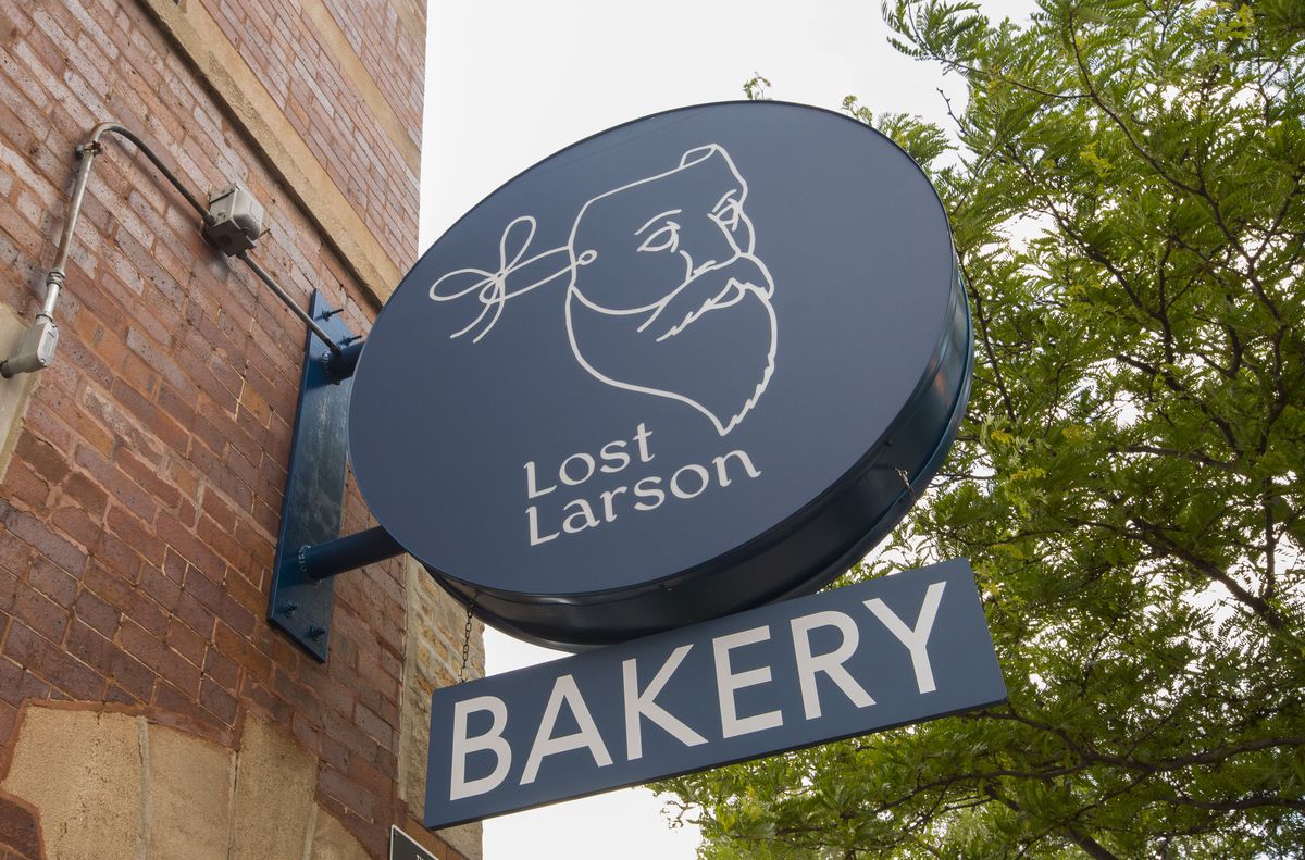 A blue sign outside a building that reads “Lost Larson.”