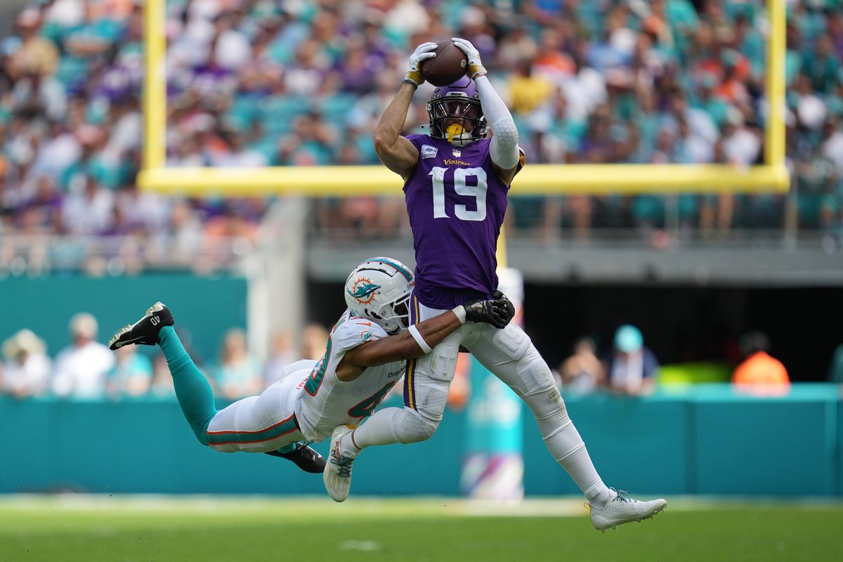 Miami Dolphins cornerback Nik Needham (40) makes a tackle on Minnesota Vikings wide receiver Adam Thielen (19) during the first half of an NFL game.