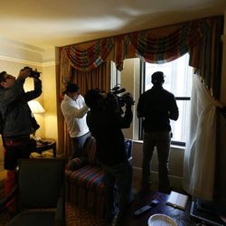 Ziggy Ansah stands by the window of his New York City hotel room while being photographed.