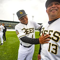 Bees' defensive coach Ray Olmedo wipes the front of hitting coach Brian Betancourth's Jersey prior to a team photo as the Salt Lake Bees hold their media day at Smith's Ballpark on Tuesday, April 2, 2019.