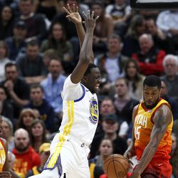 Utah Jazz forward Derrick Favors (15) strips the ball as Golden State Warriors forward Draymond Green (23) goes for the shot at Vivint Arena in Salt Lake City on Tuesday, Jan. 30, 2018.