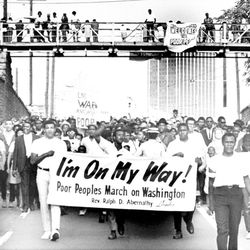 Sign-carrying participants in the southern leg of the Poor People’s Campaign march through Atlanta. | AP file photo