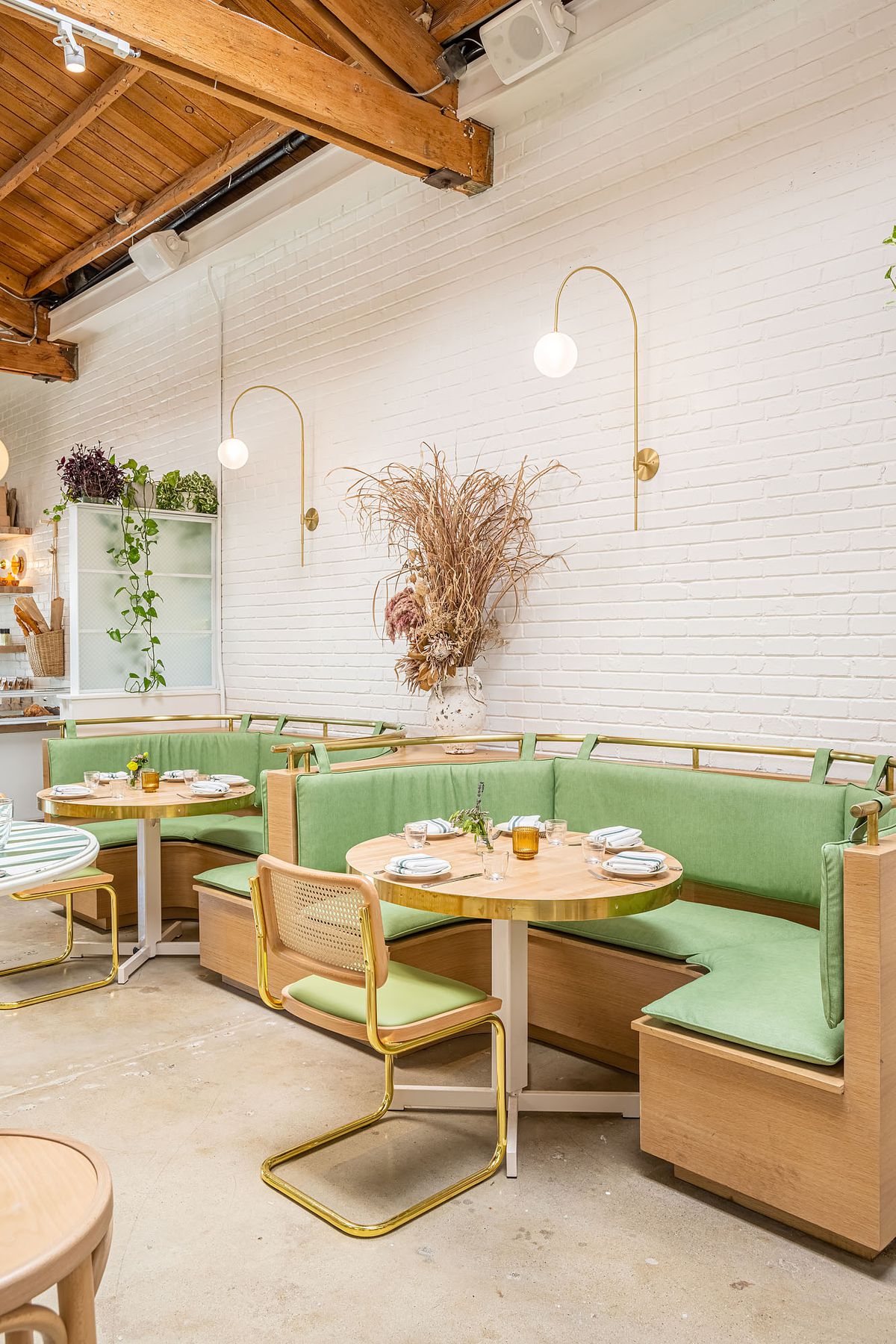 Mint green curved booths at Butcher's Daughter in West Hollywood.