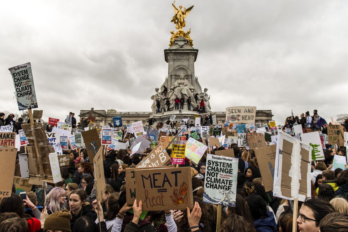 Schoolchildren gather around Queen Victoria Memorial at Buckingham Palace as they take part in a student climate protest on March 15, 2019 in London, England. 