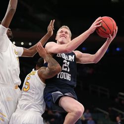 Brigham Young Cougars forward Kyle Davis (21) draws a foul on Valparaiso Crusaders guard Darien Walker (5) as BYU and Valparaiso play in NIT Semifinal action at Madison Square Garden in New York City Tuesday, March 29, 2016.