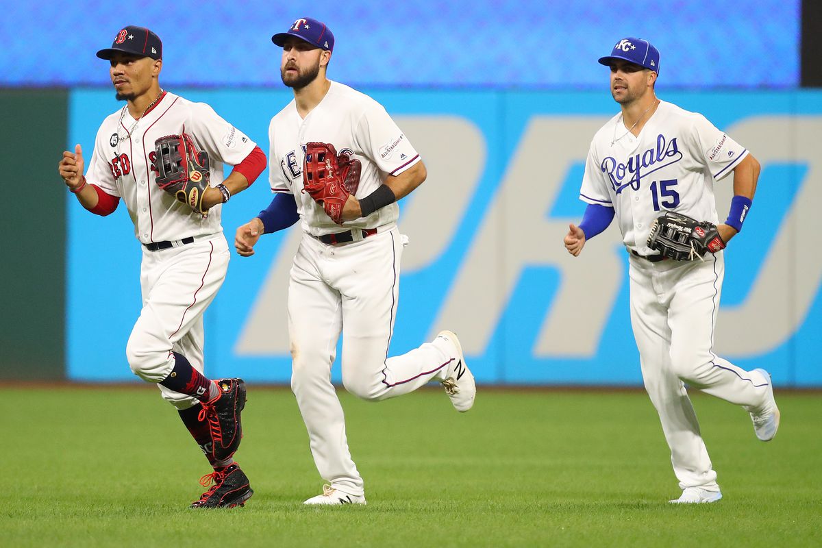 Mookie Betts #50 of the Boston Red Sox, Joey Gallo #13 of the Texas Rangers and Whit Merrifield #15 of the Kansas City Royals during the 2019 MLB All-Star Game at Progressive Field on July 09, 2019 in Cleveland, Ohio.