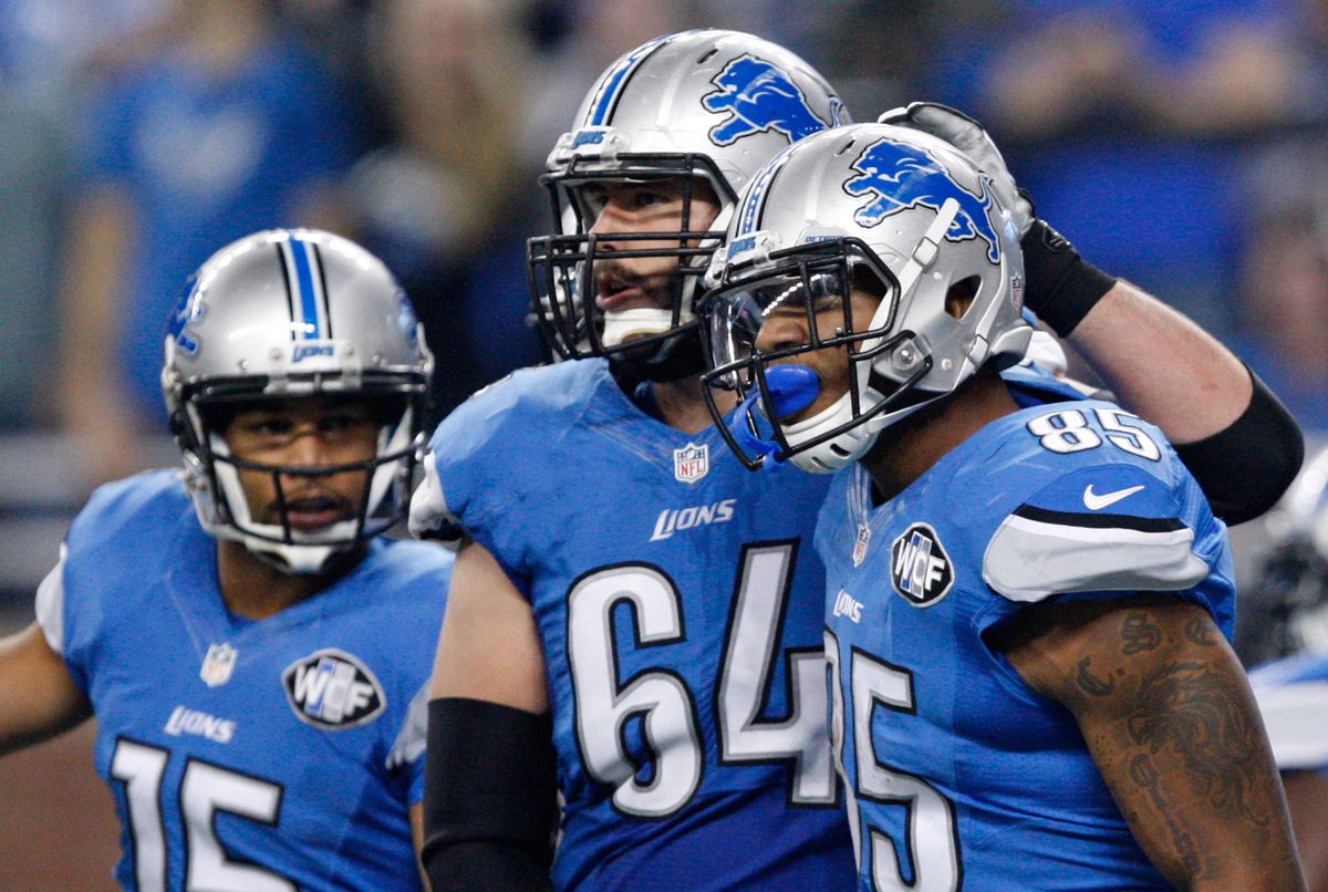 DETROIT, MI - Detroit Lions center Travis Swanson (64) celebrates a touchdown with tight end Eric Ebron (85) and receiver Golden Tate (15) during a game against the Minnesota Vikings at Ford Field.