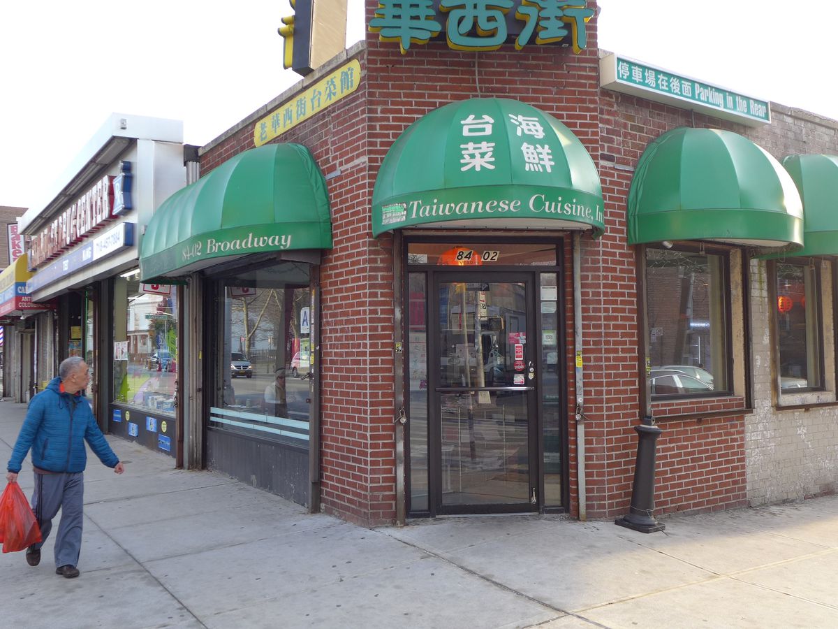 A corner location with a series of rounded green awnings.