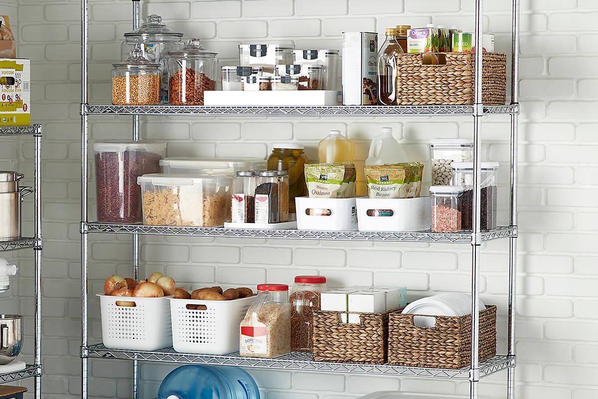 A metal shelving unit pictured in a tiled room or closet, with multiple shelves neatly stacked with canisters and bins of food items