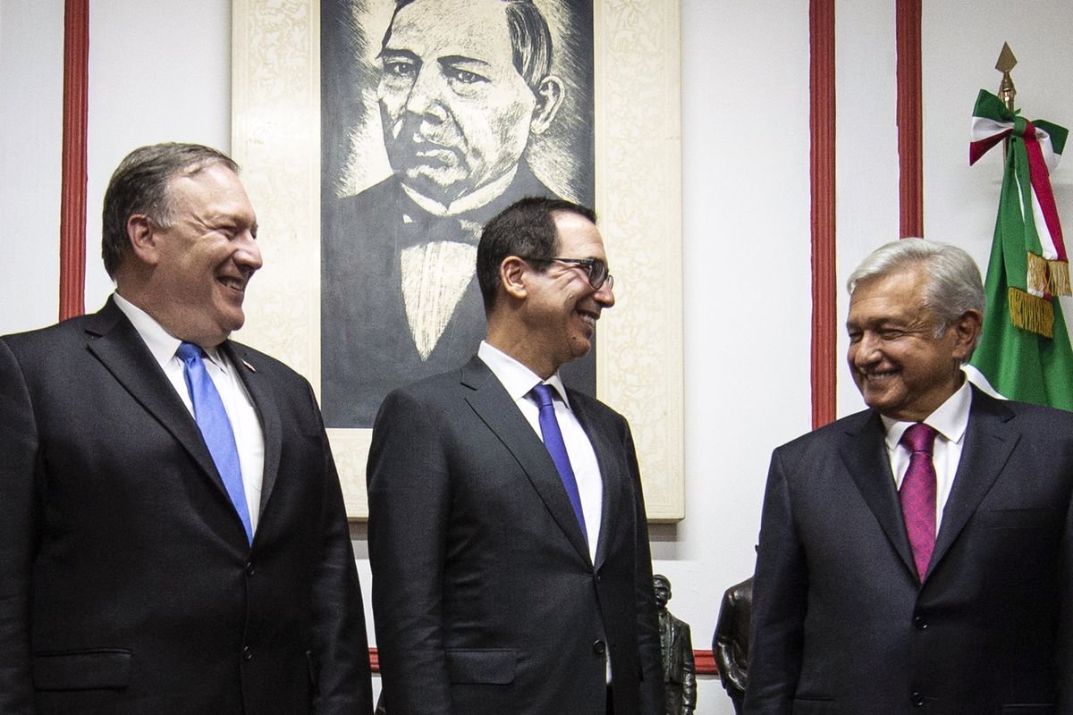 US Secretary of State Mike Pompeo and US Treasury Secretary Steven Mnuchin speak with Mexican President-elect Andres Manuel Lopez Obrador at his party’s headquarters in Mexico City, on July 13, 2018.