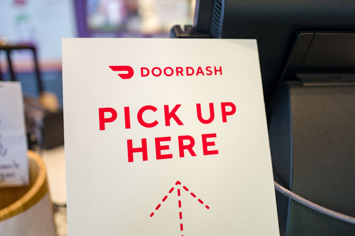 Close-up of sign for gig economy meal delivery app DoorDash.