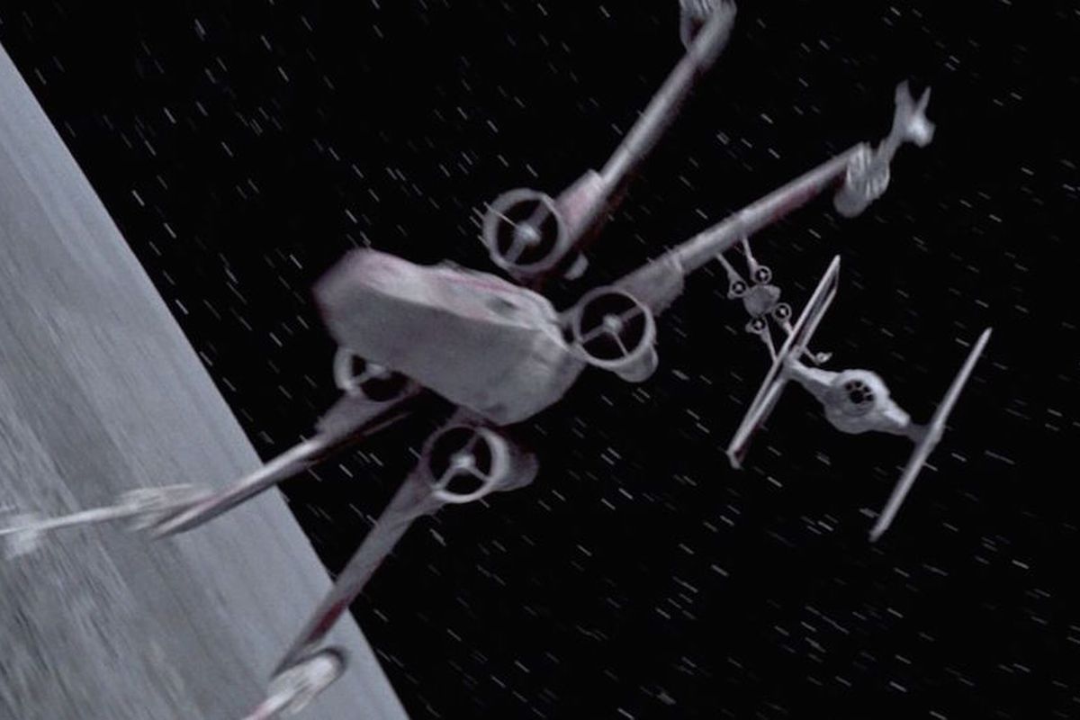 A TIE Fighter pursues an X-Wing fighter above The Death Star in Star Wars Episode IV: Special Edition (1997)