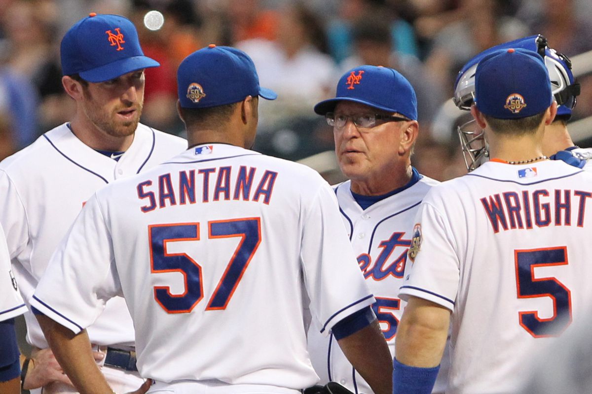 Aug 11, 2012; Flushing, NY,USA;  New York Mets pitching coach Dan Warthen (59) (glasses) visits starting pitcher Johan Santana (57) during the second inning against the Atlanta Braves at Citi Field.  Mandatory Credit: Anthony Gruppuso-US PRESSWIRE