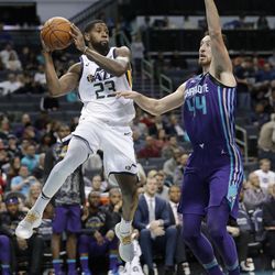 Utah Jazz's Royce O'Neale (23) looks to pass the ball as Charlotte Hornets' Frank Kaminsky (44) defends during the first half of an NBA basketball game in Charlotte, N.C., Friday, Jan. 12, 2018. (AP Photo/Chuck Burton)