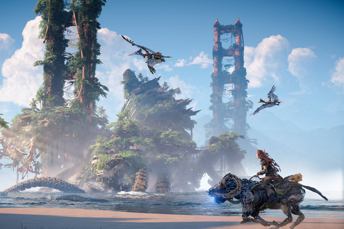 Aloy riding a Charger on a beach past the ruins of the Golden Gate Bridge in Horizon Forbidden West