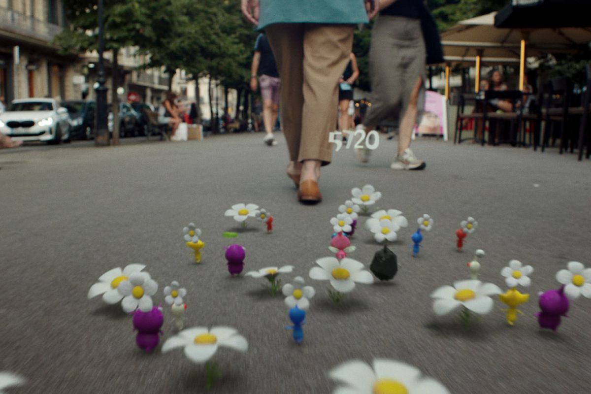 A bunch of different Pikmin chase after a person walking