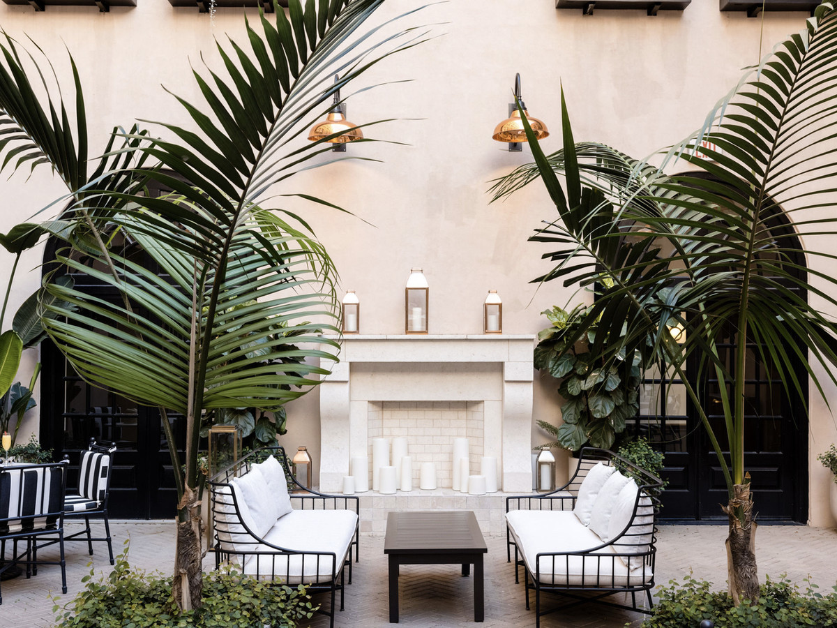 Courtyard space with palm trees and white couches