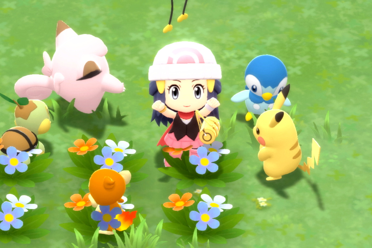 The main character from sitting alongside Pikachu and friends in a flower patch in Pokémon Brilliant Diamond and Pokémon Shining Pearl