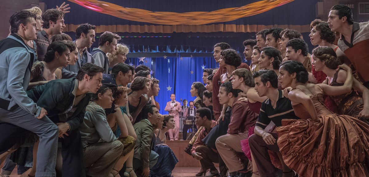Most of the cast faces off on two sides of a dance floor in Steven Spielberg’s West Side Story