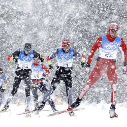 Skiers practice in heavy snowfall during a cross-country training session at the Vancouver 2010 Olympics in Whistler, British Columbia, Thursday.