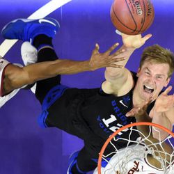 Southern California guard De'Anthony Melton, left, and BYU forward Eric Mika reach for a rebound during the first half of an NCAA college basketball game, Saturday, Dec. 3, 2016, in Los Angeles. (AP Photo/Mark J. Terrill)
