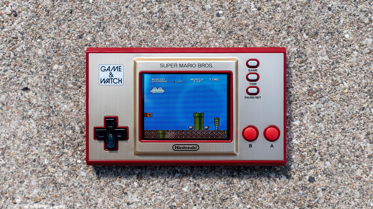 A Nintendo Game &amp; Watch: Super Mario Bros. console photographed on concrete