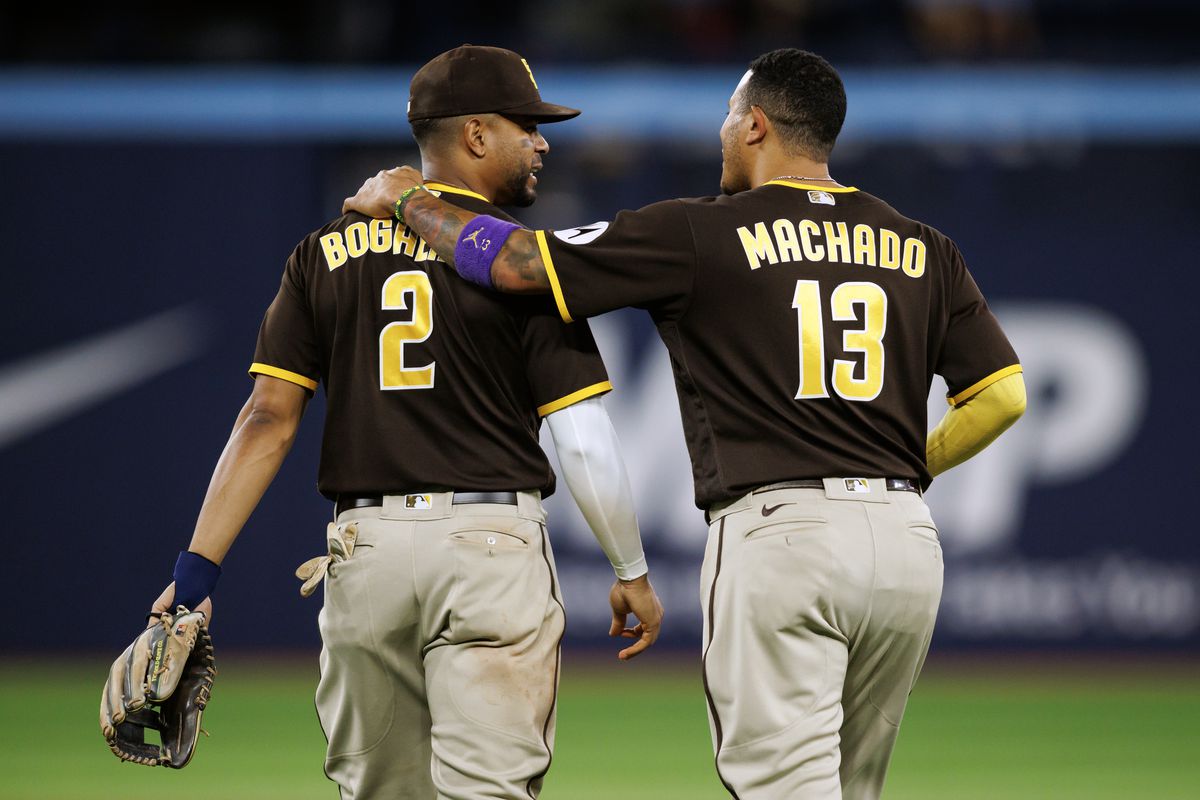 Manny Machado embraces Xander Bogaerts of the San Diego Padres as they take the field in the ninth inning against the Toronto Blue Jays at Rogers Centre on July 19, 2023 in Toronto, Canada.