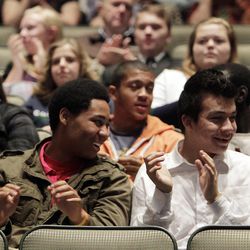 Michael Thomas, left, and Freddy Alvarado, East High School students, react during a music video performance as the Mormon Tabernacle Choir announces the launch of its new YouTube channel in Salt Lake City, Tuesday, Oct. 30, 2012. 