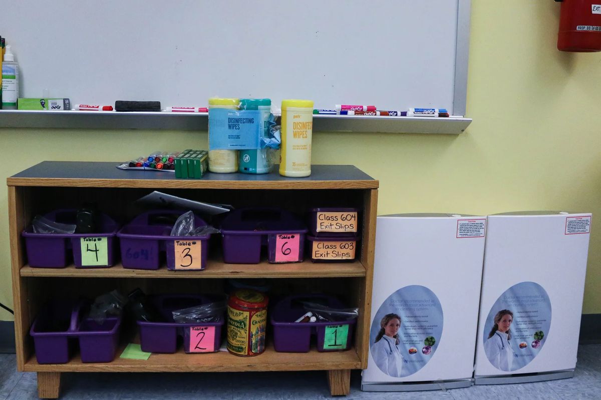 Two Intellipure air purifiers sitting in the corner of a Bronx classroom during summer school in July 2021. New York City spent more than $40 million on purifiers, but some experts think they could have gotten more for the money.