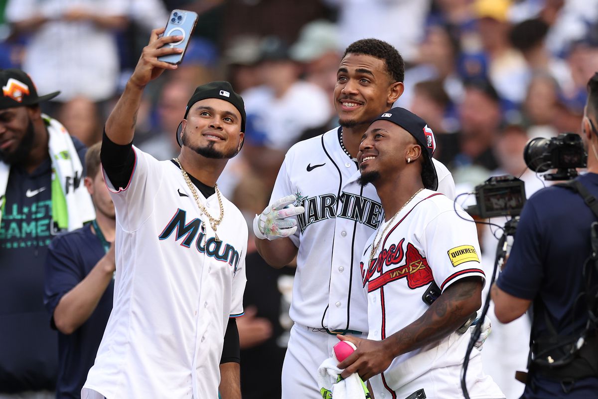 Luis Arraez #3 of the Miami Marlins takes a selfie with Ozzie Albies #1 of the Atlanta Braves and Julio Rodríguez #44 of the Seattle Mariners during the T-Mobile Home Run Derby at T-Mobile Park on July 10, 2023 in Seattle, Washington.  