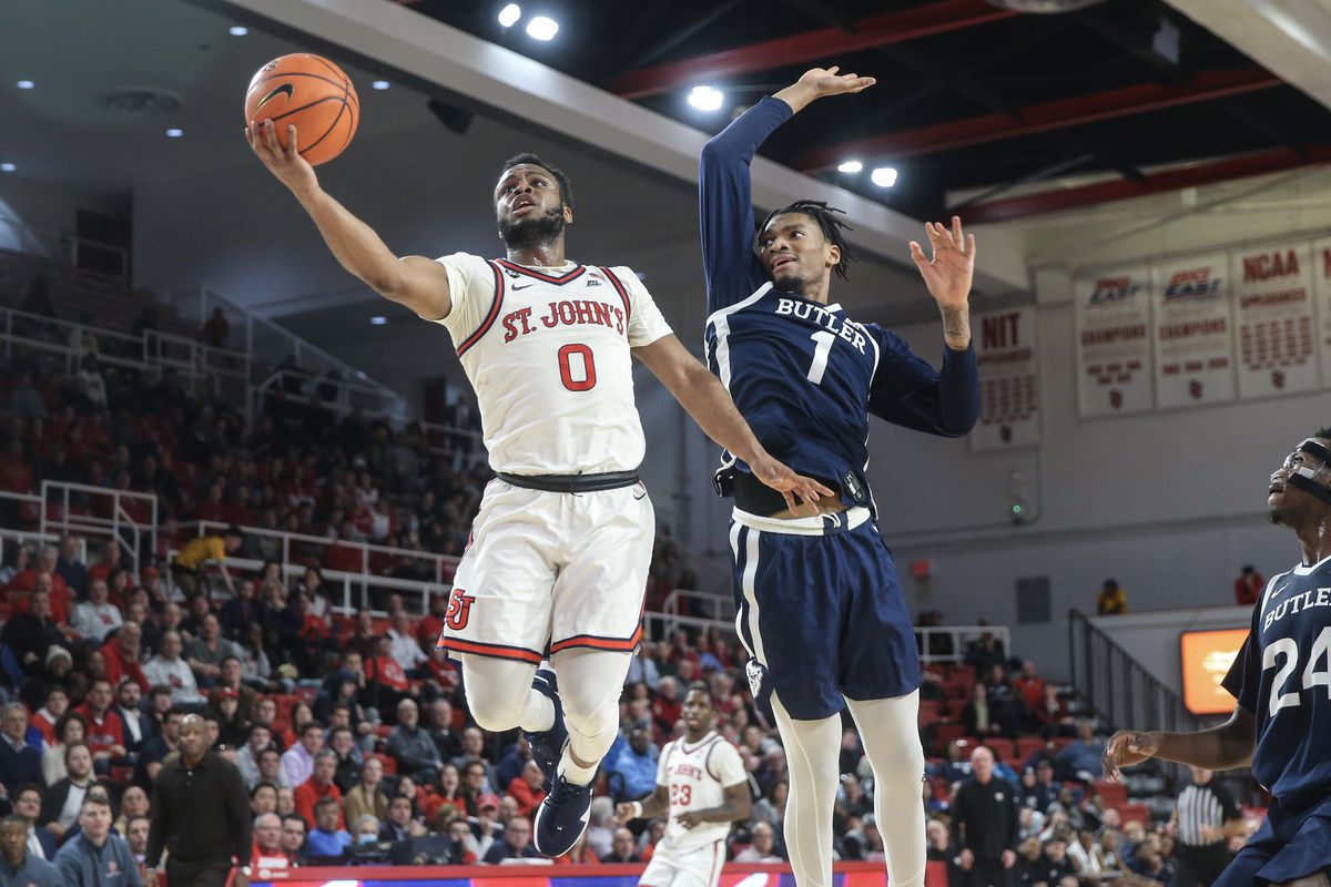 Jan 10, 2023; Queens, New York, USA; St. John’s Red Storm guard Posh Alexander (0) drives past Butler Bulldogs forward Jalen Thomas (1) for a layup in the second half at Carnesecca Arena. Mandatory Credit: Wendell Cruz