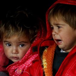 Syrian refugee babies sit in a tent in an improvised camp on the border line between Macedonia and Serbia near the northern Macedonian village of Tabanovce, Friday, March 11, 2016. About 1,500 refugees remain stranded at the Macedonian border with Serbia as the borders on the Balkan migrant route are closing. 