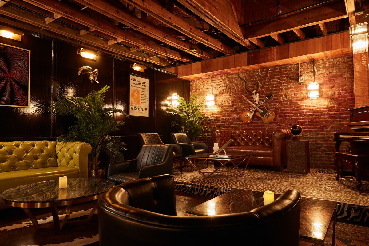 A boozy lounge with guitars on the wall and lots of brick and leather.