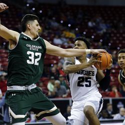 Utah State Aggies forward Dwayne Brown Jr. drives to the hoop with Colorado State Rams forward Nico Carvacho defending during the Mountain West Conference basketball tournament in Las Vegas on Wednesday, March 7, 2018.