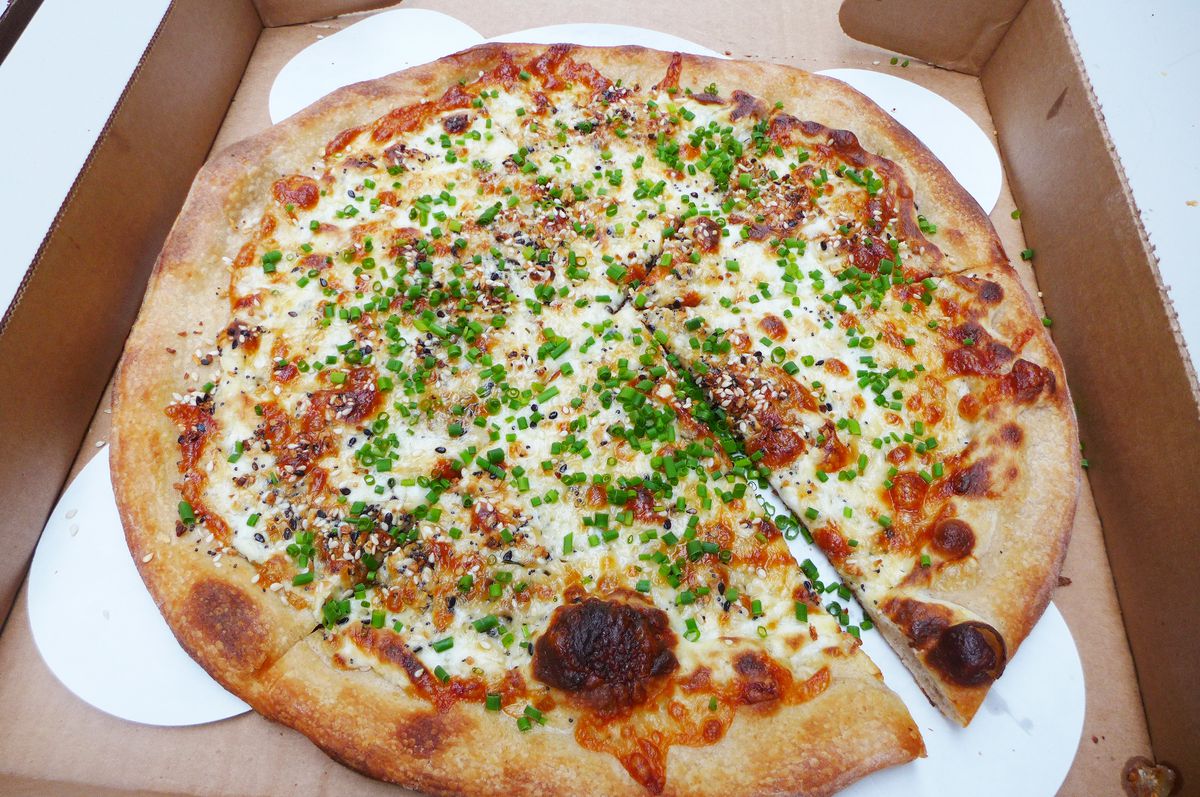 A pizza with everything spices on top.