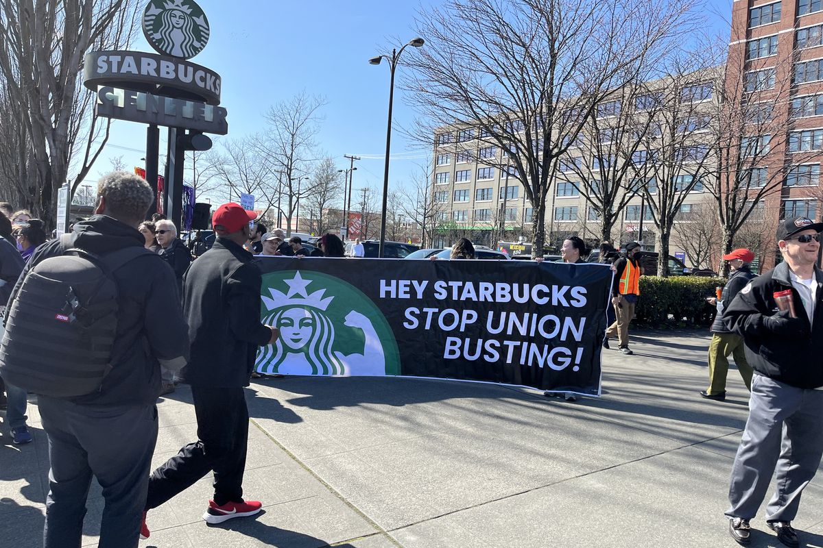A banner at a protest that reads, “Hey Starbucks, stop union busting!”