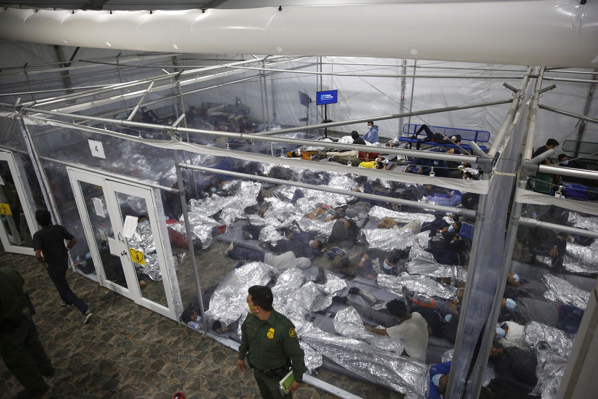 Young immigrant children lie inside a pod at the Department of Homeland Security holding facility in Donna, Texas, the main detention center for unaccompanied children in the Rio Grande Valley run by U.S. Customs and Border Protection.