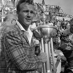 File-This May 14, 1962, file photo shows Arnold Palmer holding the trophy cup after he defeated Johnny Pott, 69-73, in an 180-hole playoff match at the Colonial National Invitation golf tournament at Fort Worth, Texas. Palmer, who made golf popular for the masses with his hard-charging style, incomparable charisma and a personal touch that made him known throughout the golf world as "The King," died Sunday, Sept. 25, 2016, in Pittsburgh. He was 87.