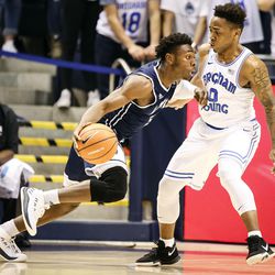 Loyola Marymount Lions guard James Batemon (5) attempts to dribble around Brigham Young Cougars guard Jahshire Hardnett (0) as the Brigham Young Cougars take on the Loyola Marymount Lions at the Marriott Center in Provo on Thursday, Jan. 18, 2018.