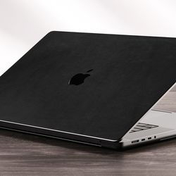 <em>Dbrand’s black leather skin on a MacBook.</em>