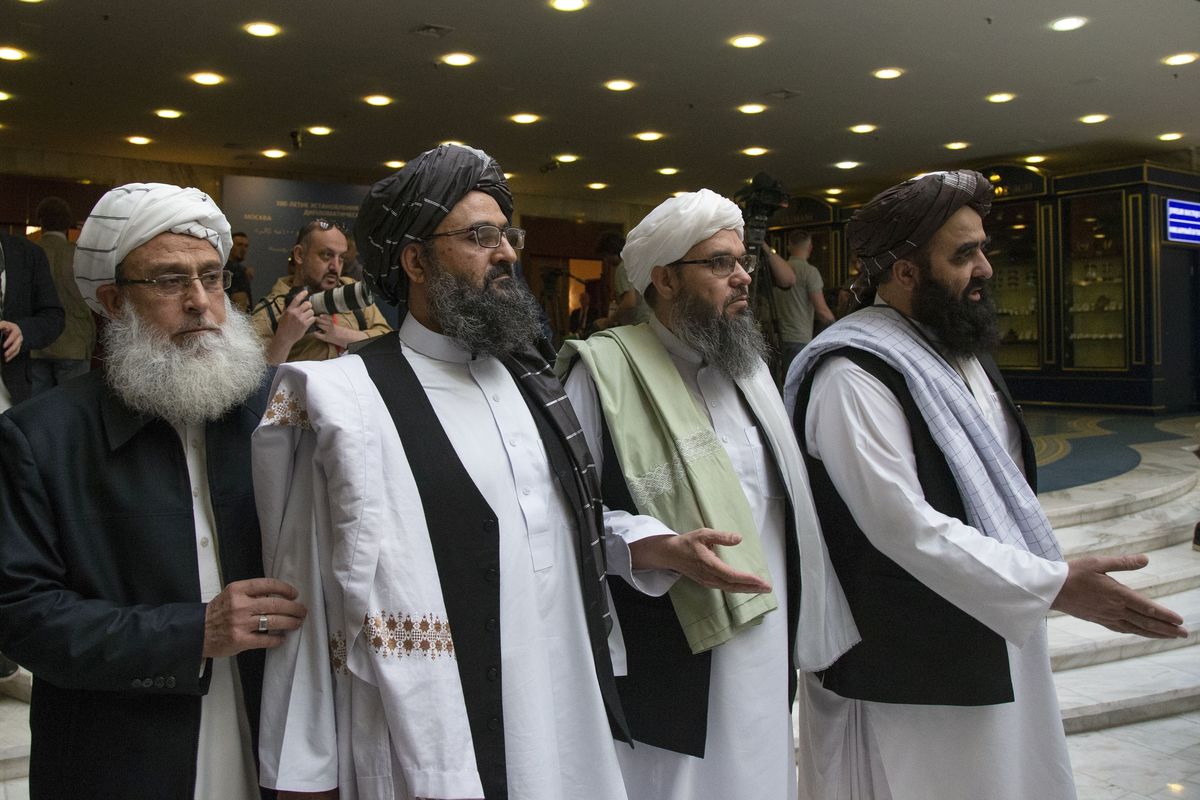 FILE - In this file photo taken on Tuesday, May 28, 2019, Mullah Abdul Ghani Baradar, the Taliban group's top political leader, second from left, arrives with other members of the Taliban delegation for talks in Moscow, Russia. The seventh and latest roun
