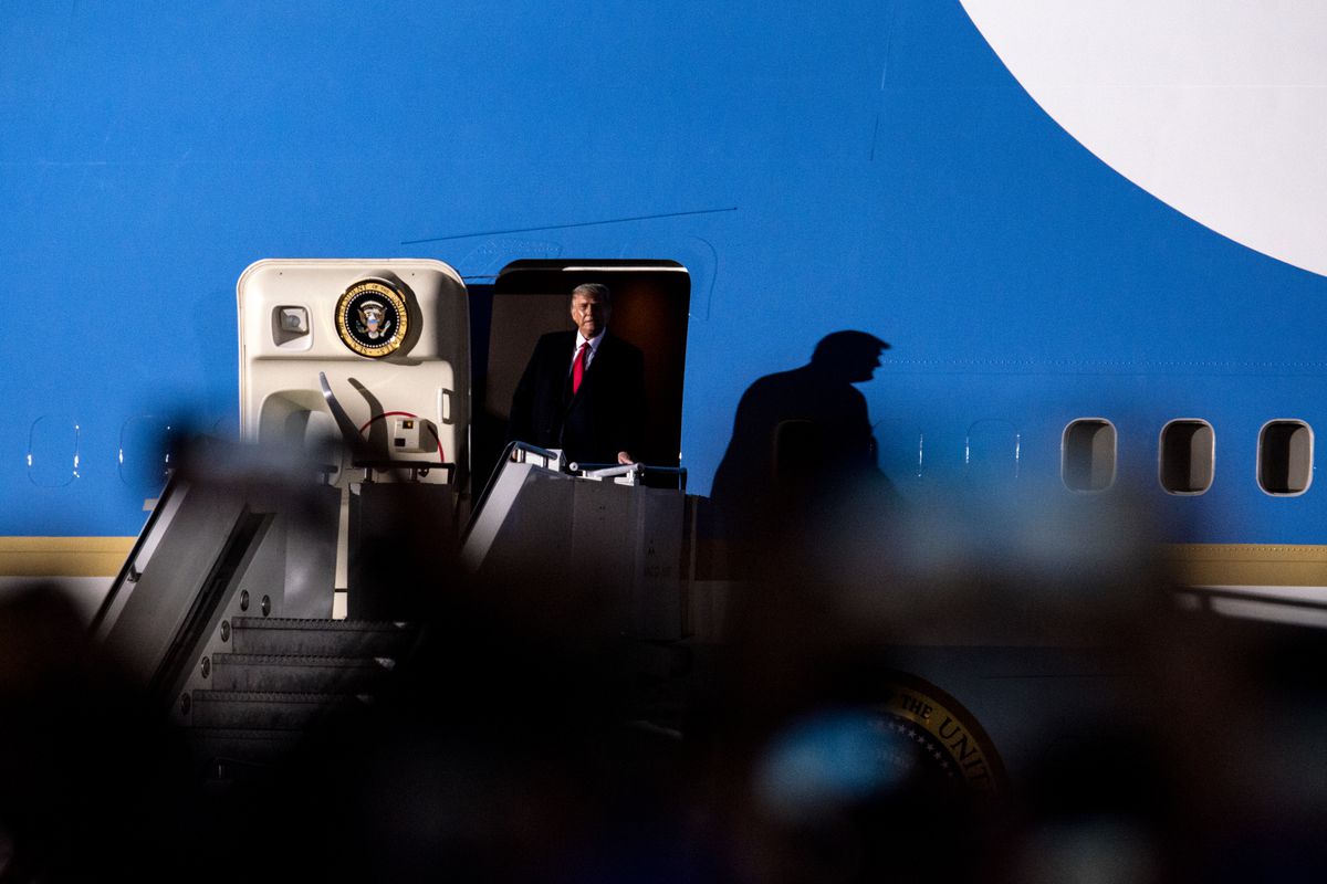 President Trump standing in the doorway of the Air Force One airplane.