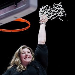 Bingham head coach Charron Mason clips the net as her team celebrates their win over Fremont in the 6A girls basketball championship game at the Huntsman Center in Salt Lake City on Saturday, Feb. 29, 2020.