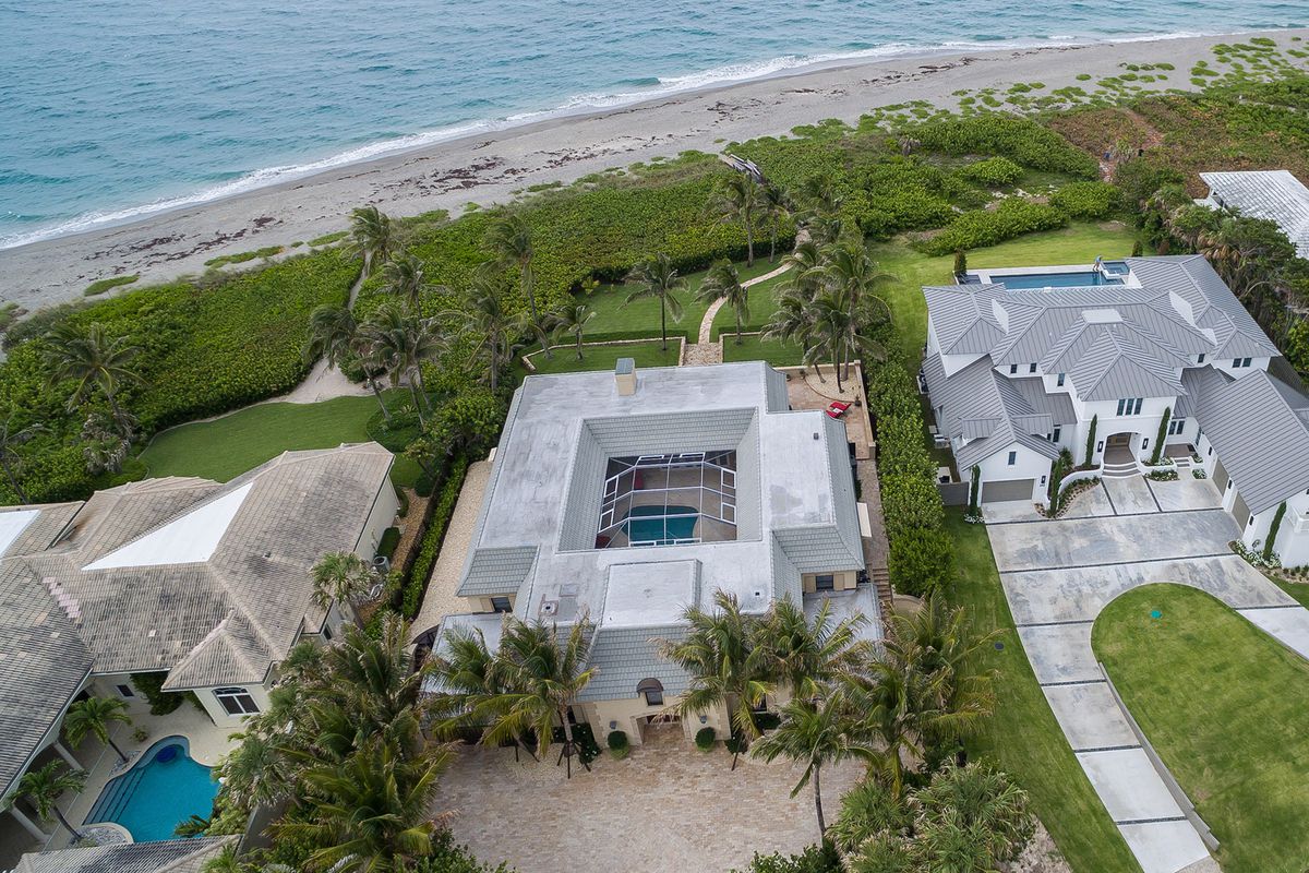 An oceanfront home in Jupiter with the beach in the background