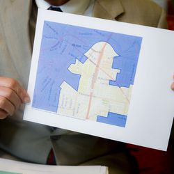 FILE - In this Thursday, April 11, 2019, file photo David Niven, a professor of political science at the University of Cincinnati, holds a map demonstrating a gerrymandered Ohio district in Cincinnati. The Supreme Court said, by a 5-4 vote on Thursday, June 27, 2019, that claims of partisan gerrymandering do not belong in federal court. The court's conservative, Republican-appointed majority says that voters and elected officials should be the arbiters of what is a political dispute The decision effectively reverses the outcome of rulings in Maryland, Michigan, North Carolina and Ohio, where courts had ordered new maps drawn. (AP Photo/John Minchillo, File)
