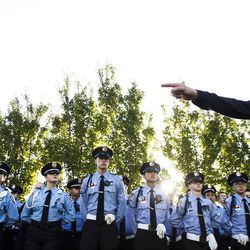 Cody Lougy, of the Salt Lake City Police Department, gives directions to the Sandy Explores at the Utah Law Enforcement Memorial in Salt Lake City on Thursday, July 14, 2016, during a vigil to honor the Dallas police officers killed and injured in the line of duty last week.