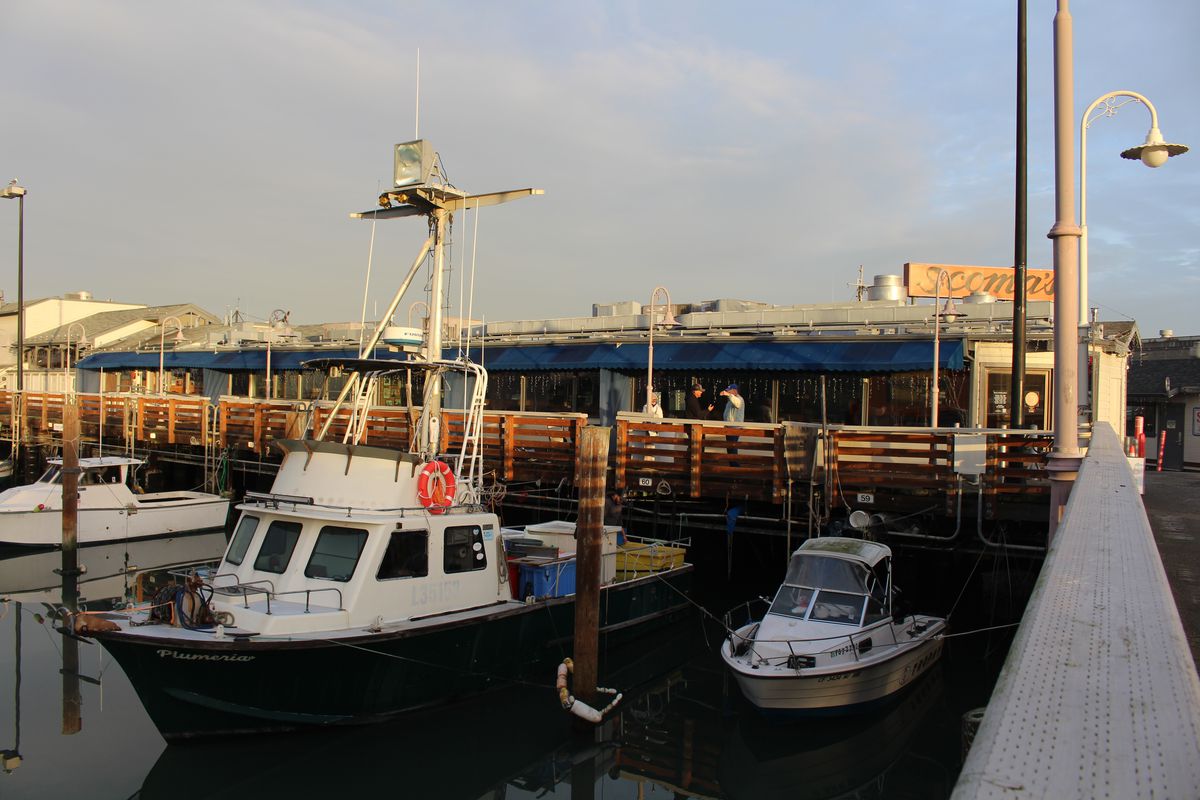 Three boats are tied to the dock outside of San Francisco restaurant Scoma’s; this is where the fishing boat Plumeria sells Dungeness crab.