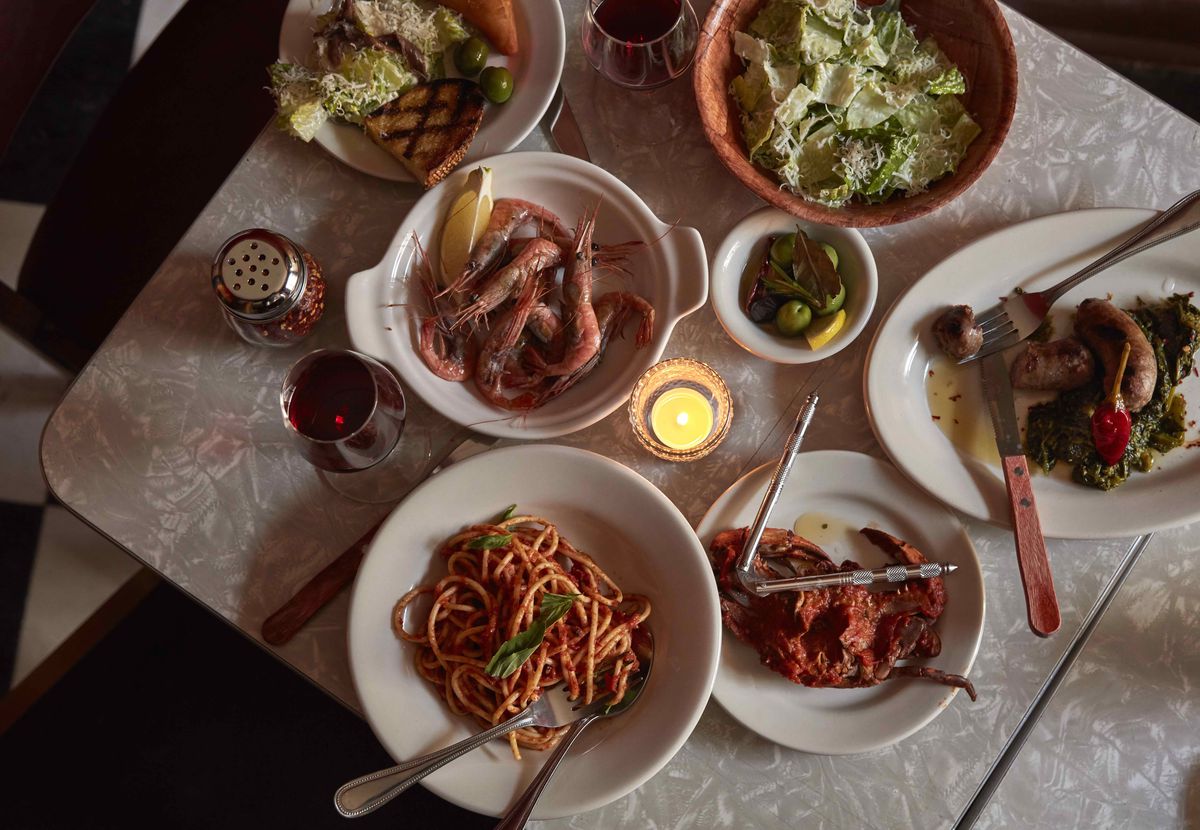 overhead shot of a table with several italian dishes